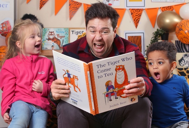 Sam Nixon reading ‘The Tiger Who Came to Tea’ to children at McMillan Nursery School.