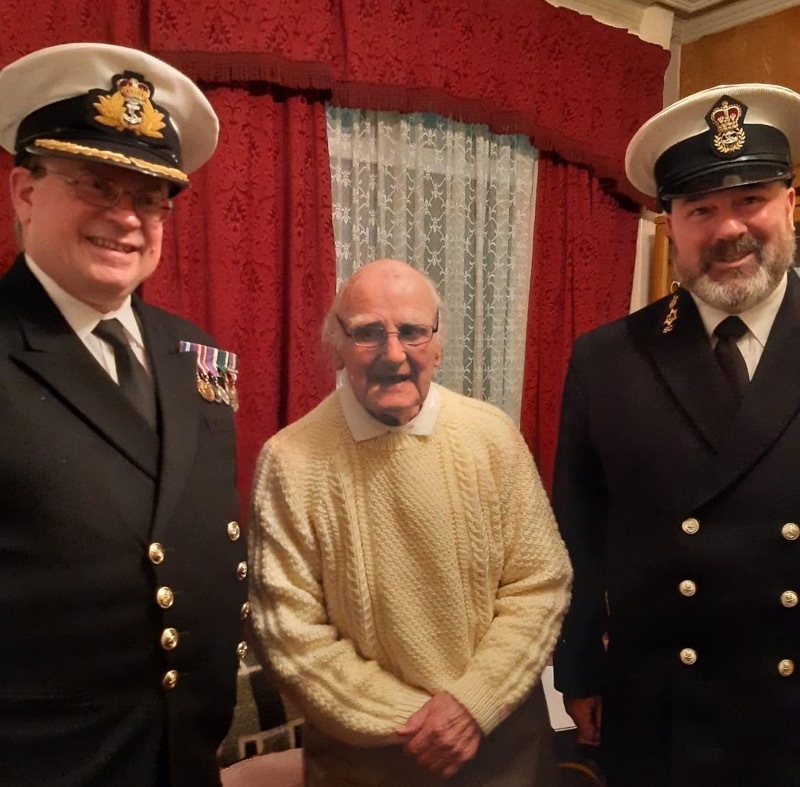 Frank White with Commander David Noakes and another officer in the Royal Navy.