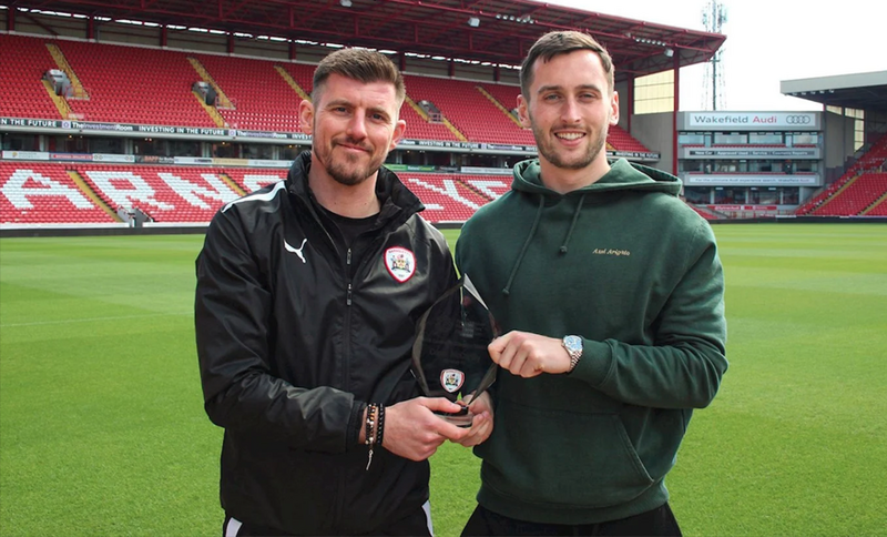 COMMUNITY CHAMPION: Conor McCarthy with Reds in the Community head of education Mark Crossfield.
