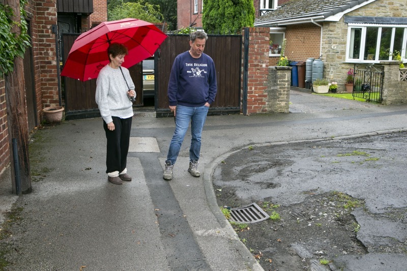 Flooding Issues : Jenny and Robert Pashley near the drain outside their home which cannot cope with rainfall and floods their home. Picture Shaun Colborn PD092418