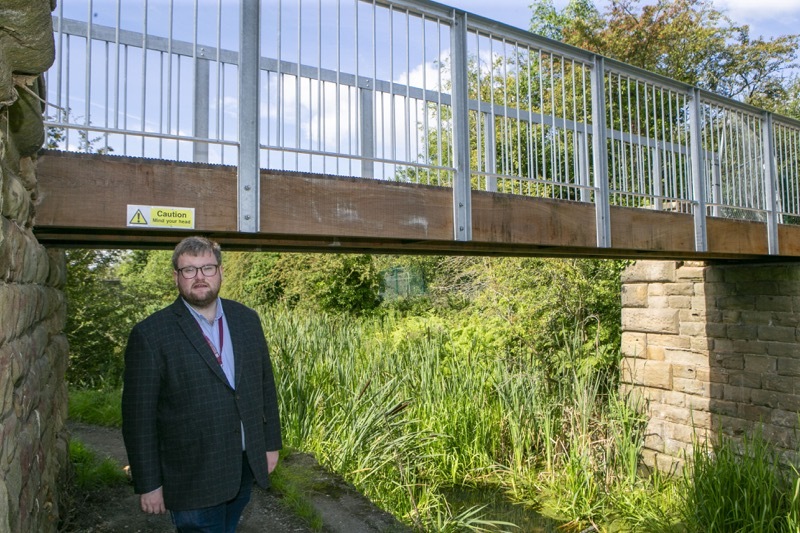Bridging the gap: Coun James Higginbottom on the new bridge which hsa been over 12 months in the making, and units Greenland with Cortonwood. Picture Shaun Colborn PD092422