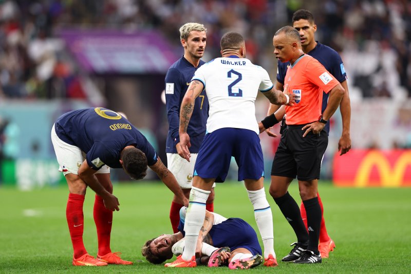 Ouch: John Stones after picking up an injury at the end of England’s loss to France.  Also pictured are France’s Olivier Giroud, Antoine Griezmann and Raphaël  Varane and England’s Kyle Walker. Picture: Getty Images.