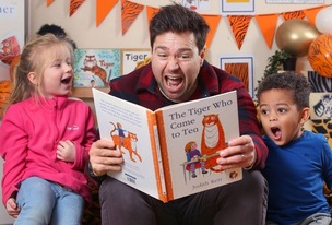 Sam Nixon reading ‘The Tiger Who Came to Tea’ to children at McMillan Nursery School.