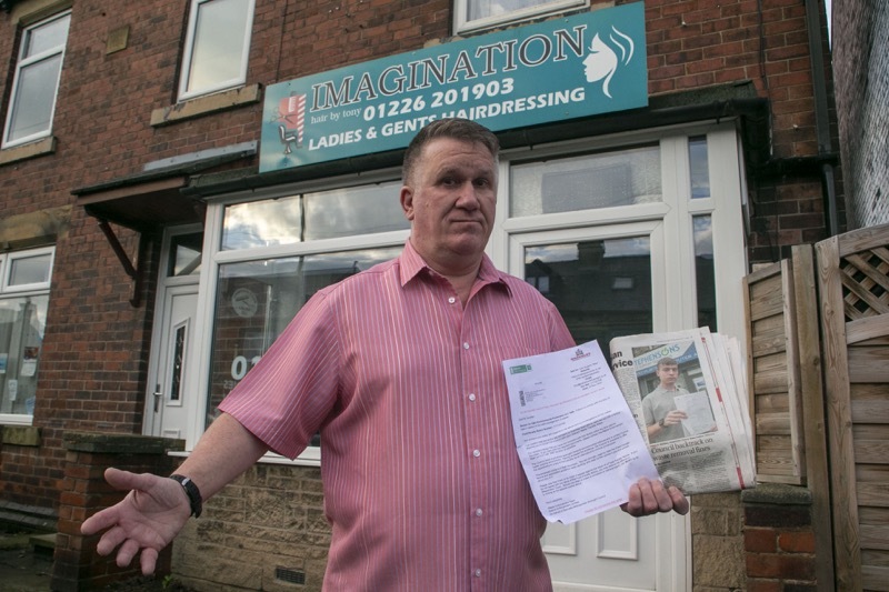 Fine Hair: Tony Swinden with his fine for putting customers hair in the bin. Picture Shaun Colborn PD091822
