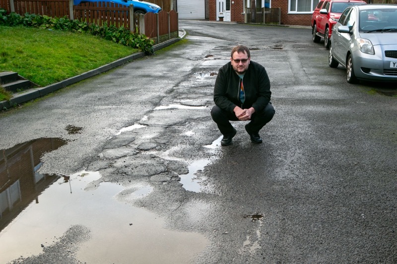 Wray of hope: Local resident Chris Wray, at one of the many Potholed and Bad road surface sites, in and around Gilroyd and Dodworth. Picture Shaun Colborn PD092797