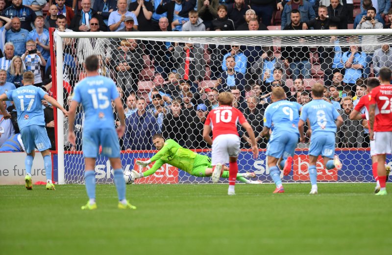 Brad Collins saves a penalty against Coventry in 2021