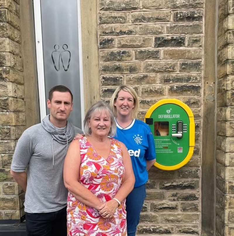 UNVEIL: Neil, Kath and Katie Austin with the defibrillator.