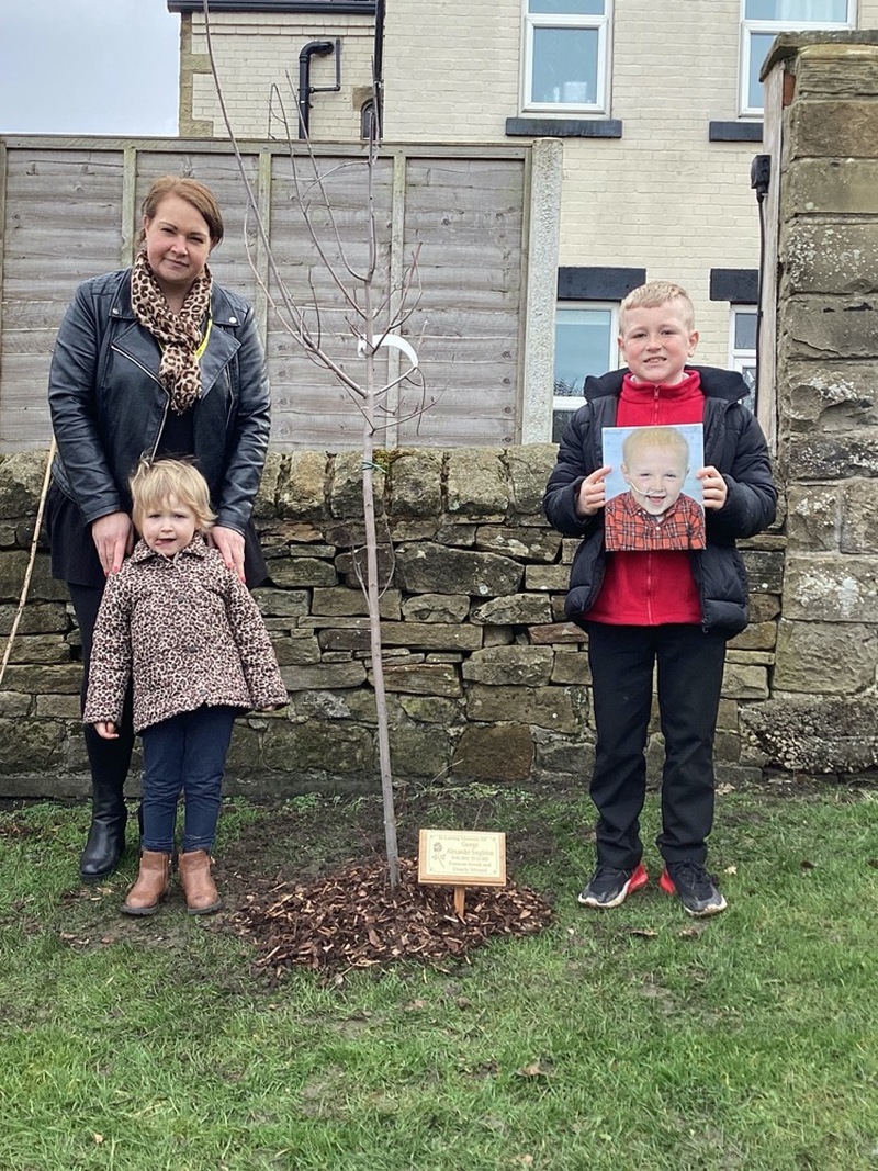 REMEMBRANCE: George Singleton’s family gather at the tree, which was planted at St John’s Primary in Penistone on Monday.