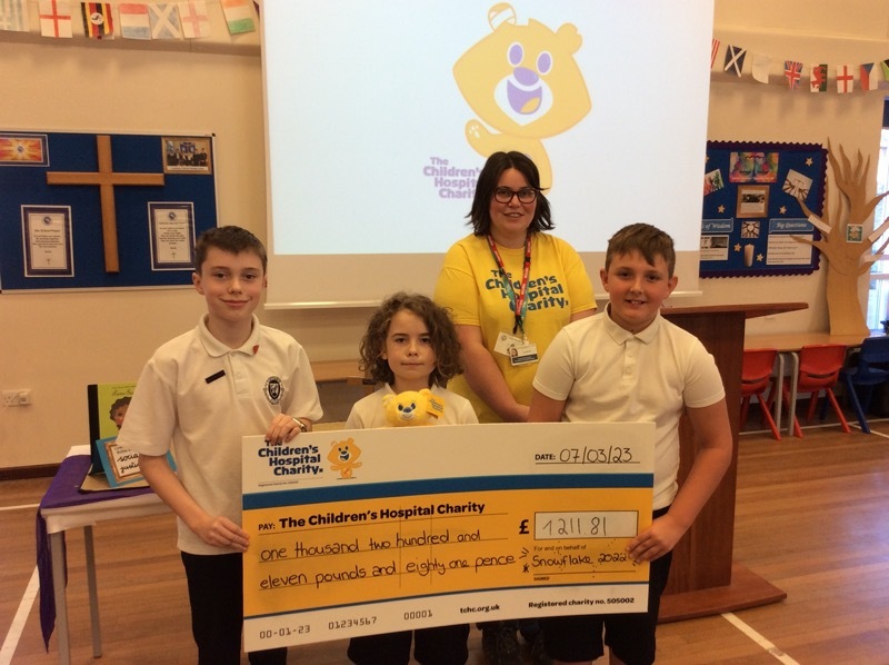 DONATION: Janet Malsch from the charity with pupils Harley Dennis, Lucas Haller-East and George Bates.