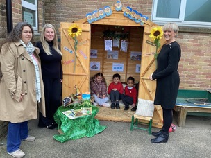 Parent governor Vanessa Pinhao, reading leader Lucy Tucker and teaching assistant Lisa Lowbridge opening the new Reading Shed, which Zak Rahim, Paisley Nixon and Kayla Dube are sitting in.