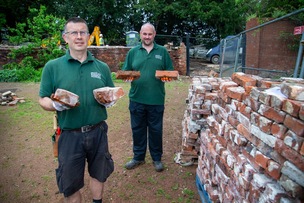 BRICK BY BRICK: Workers rebuilding the crumbling wall at Cannon Hall grounds. Picture Shaun Colborn PD093164