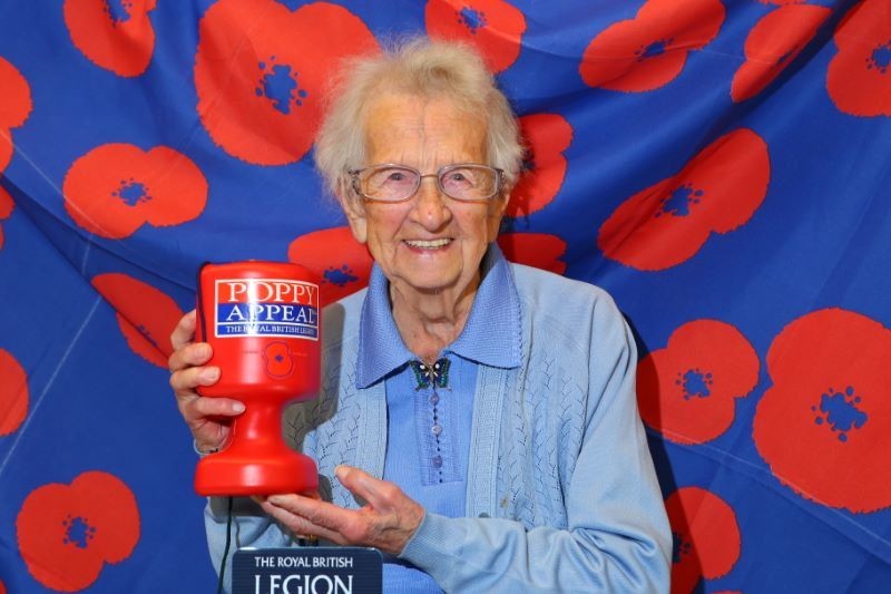 Main image for Poppy seller Agnes hanging up her tin at 98
