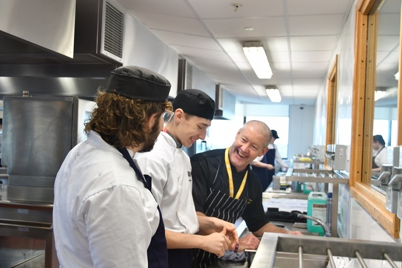 GETTING A TASTE: Richard Punshon with the college students.