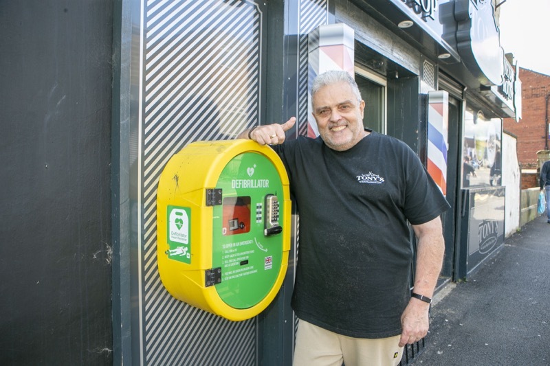 Batty Barber Back in Business: Tony Batty is reunited with another defib unit outside his salon. Picture Shaun Colborn PD092480