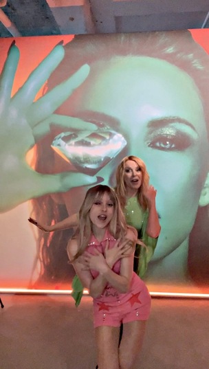 Kelsey Ellison and Kylie Minogue dancing at the Tension album launch event.